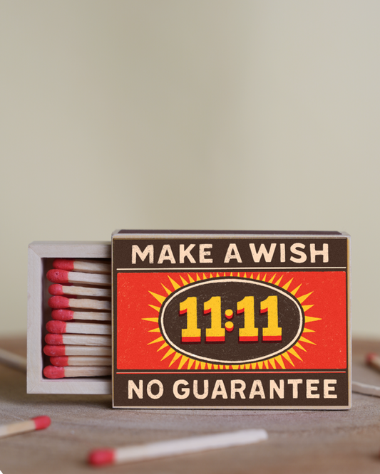 Matches box with 'Make a Wish 11:11 No Guarantee' text on a neutral background
